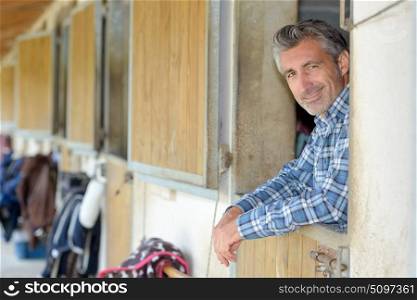 Man leaning over stable door