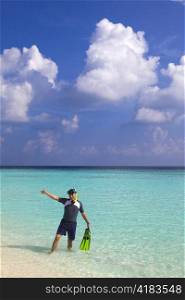 Man leaves with flippers and mask of ocean, Maldives