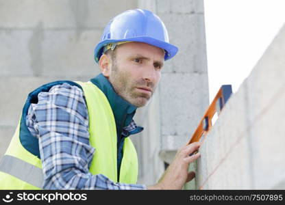 man levelling before laying the paving stones