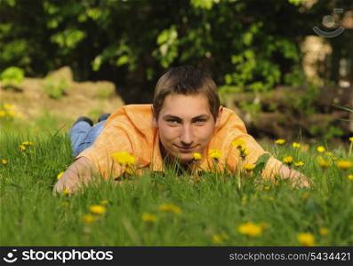 Man lie on the grass and look up. Shallow DOF. Outdoor portrait