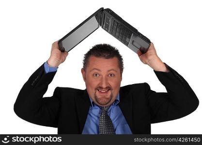 Man lifting computer over his head