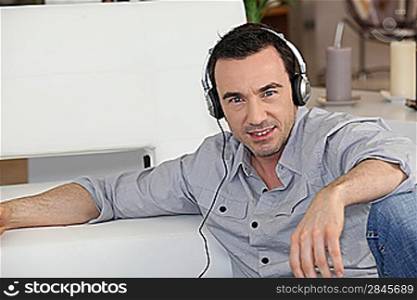 man listening music at home