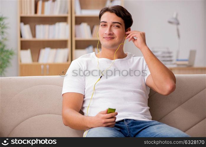 Man listening music sitting in couch