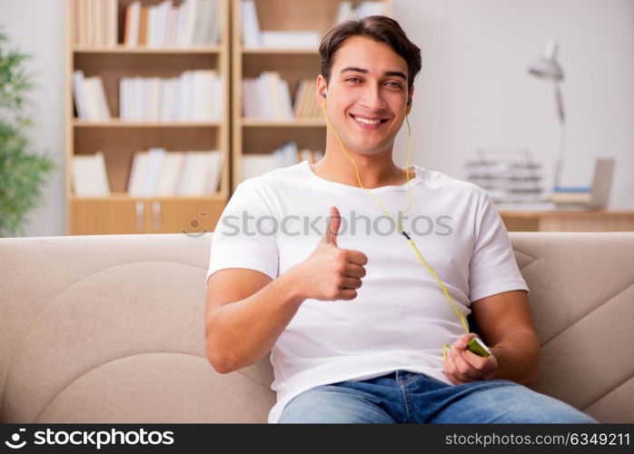 Man listening music sitting in couch