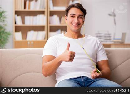 Man listening music sitting in couch