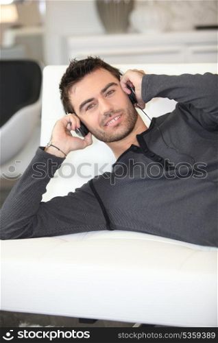 man listening to music on sofa
