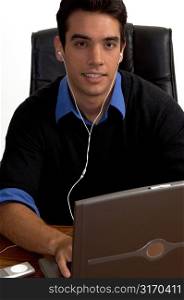 Man Listening With Earphones While Using Laptop