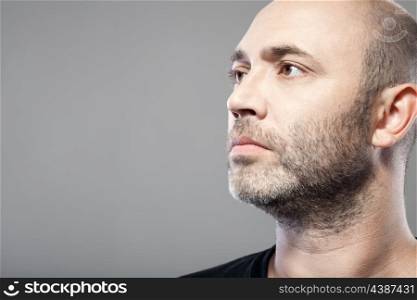 man look into the distance isolated on gray background with copyspace