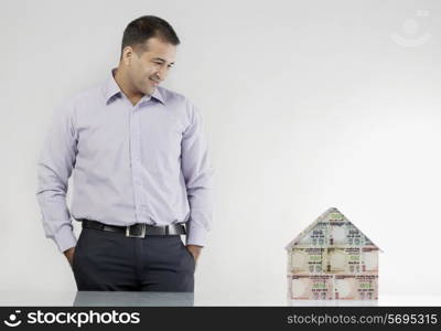 Man looking at a house model