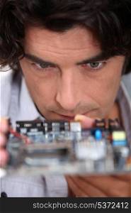 Man looking at a motherboard