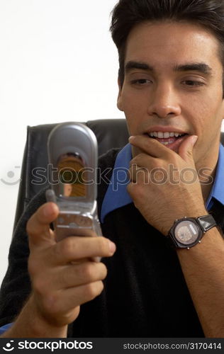 Man Looking at Cell Phone Screen