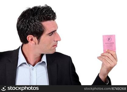 Man looking at driving licence