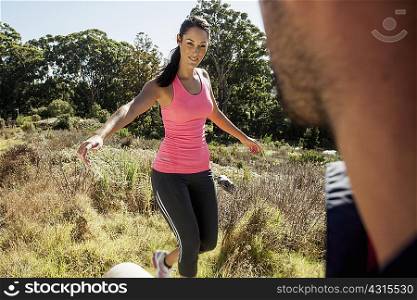 Man looking at female jogger balancing