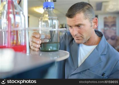 Man looking at glass jar