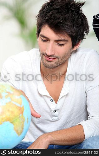 Man looking at globe