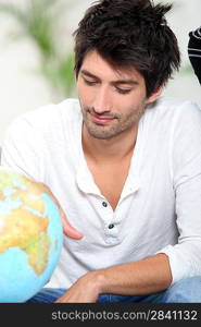 Man looking at globe