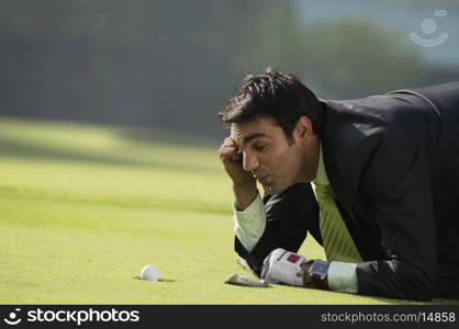 Man looking at golf ball