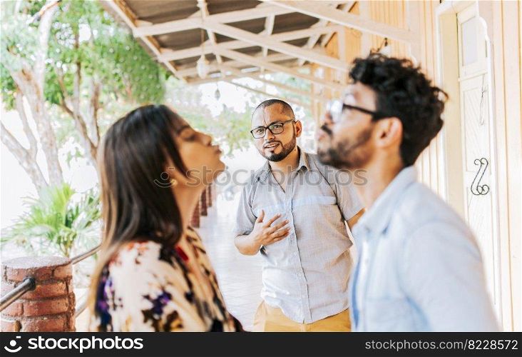 Man looking at his cheating girlfriend kissing another woman outdoors, Man discovering his cheating girlfriend kissing another man in the street, Boyfriend discovering his girlfriend’s infidelity outdoors