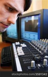 Man Looking at Levels on Mixing Board
