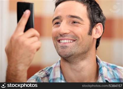 Man looking at phone smiling