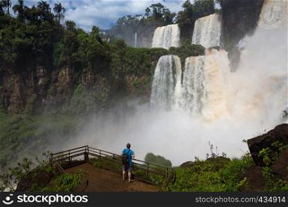 man looking at the wellknown Iguacu waterfalls