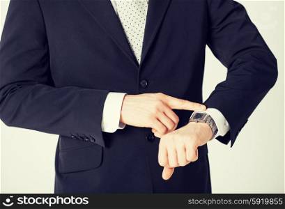 man looking at wristwatch. close up of man looking at wristwatch
