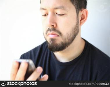 man looking down at his smartphone