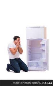 Man looking for food in empty fridge