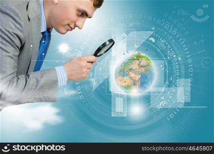 Man looking in magnifier. Image of businessman examining objects with magnifier. Elements of this image are furnished by NASA