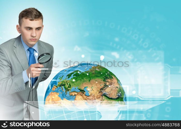 Man looking in magnifier. Image of businessman examining objects with magnifier. Elements of this image are furnished by NASA