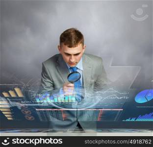 Man looking in magnifier. Image of businessman examining objects with magnifier