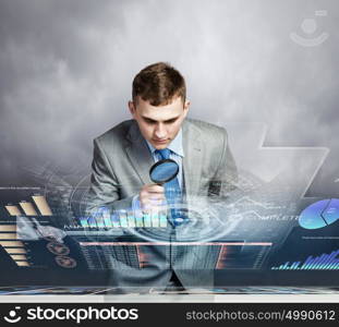 Man looking in magnifier. Image of businessman examining objects with magnifier