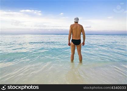 Man looking out at sea before swim