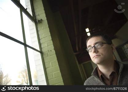 Man looking out of a window
