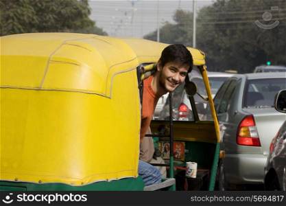 Man looking out of an auto rickshaw