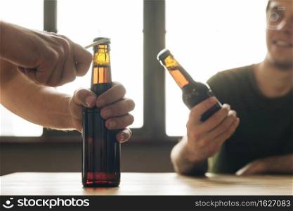 man looking person opening brown beer bottle restaurant