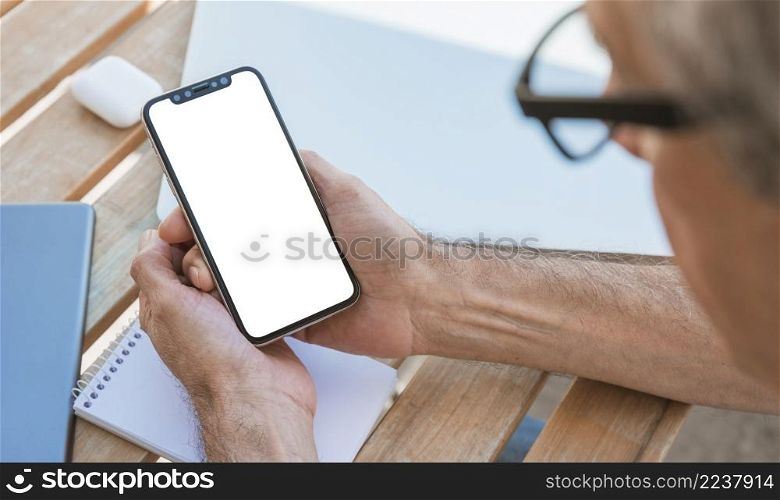 man looking smart phone with blank white screen