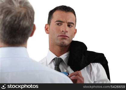 Man looking suspiciously at his colleague