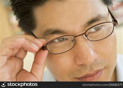 Man Looking Through New Glasses