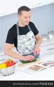 man looking up recipe in kitchen
