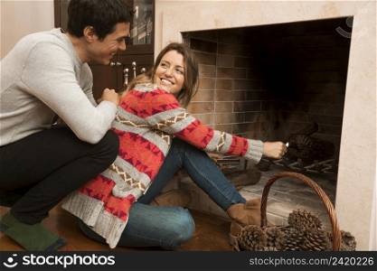 man looking young woman ignite big match fireplace