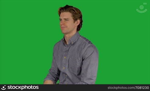 Man looks at camera quizzically (Green Key)