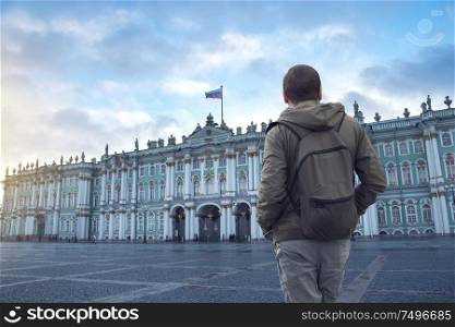 man looks at the winter palace in the city of St. Petersburg. Russia.