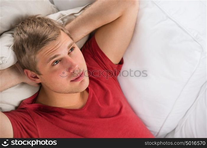 Man lying down on sofa and relaxing