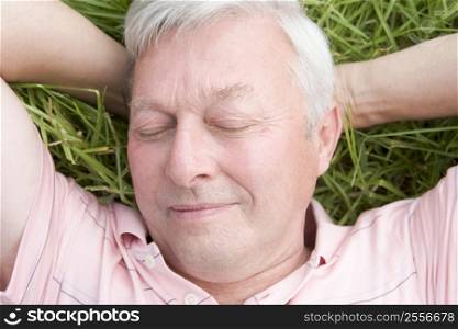 Man lying in grass sleeping