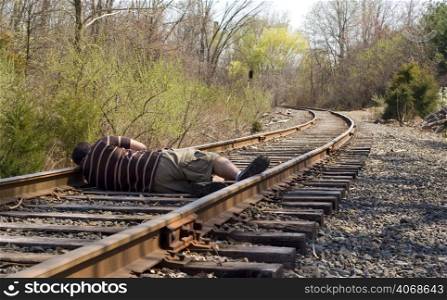 Man lying on train tracks