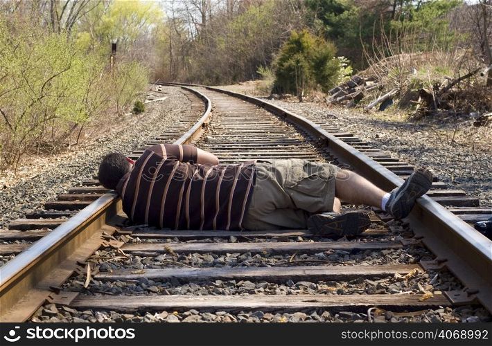 Man lying on train tracks