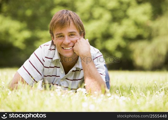 Man lying outdoors smiling