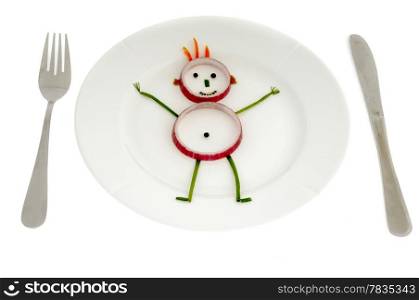 Man made of vegetables on a dish.