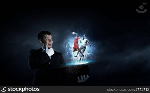 Man magician with cylinder hat. Young cheerful businessman making tricks with magic hat